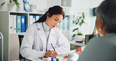 Buy stock photo Writing, prescription and doctor with patient, office or notes for assessment, women or appointment. Clinic, mature people and medical professional with notebook for diagnosis, serious and healthcare