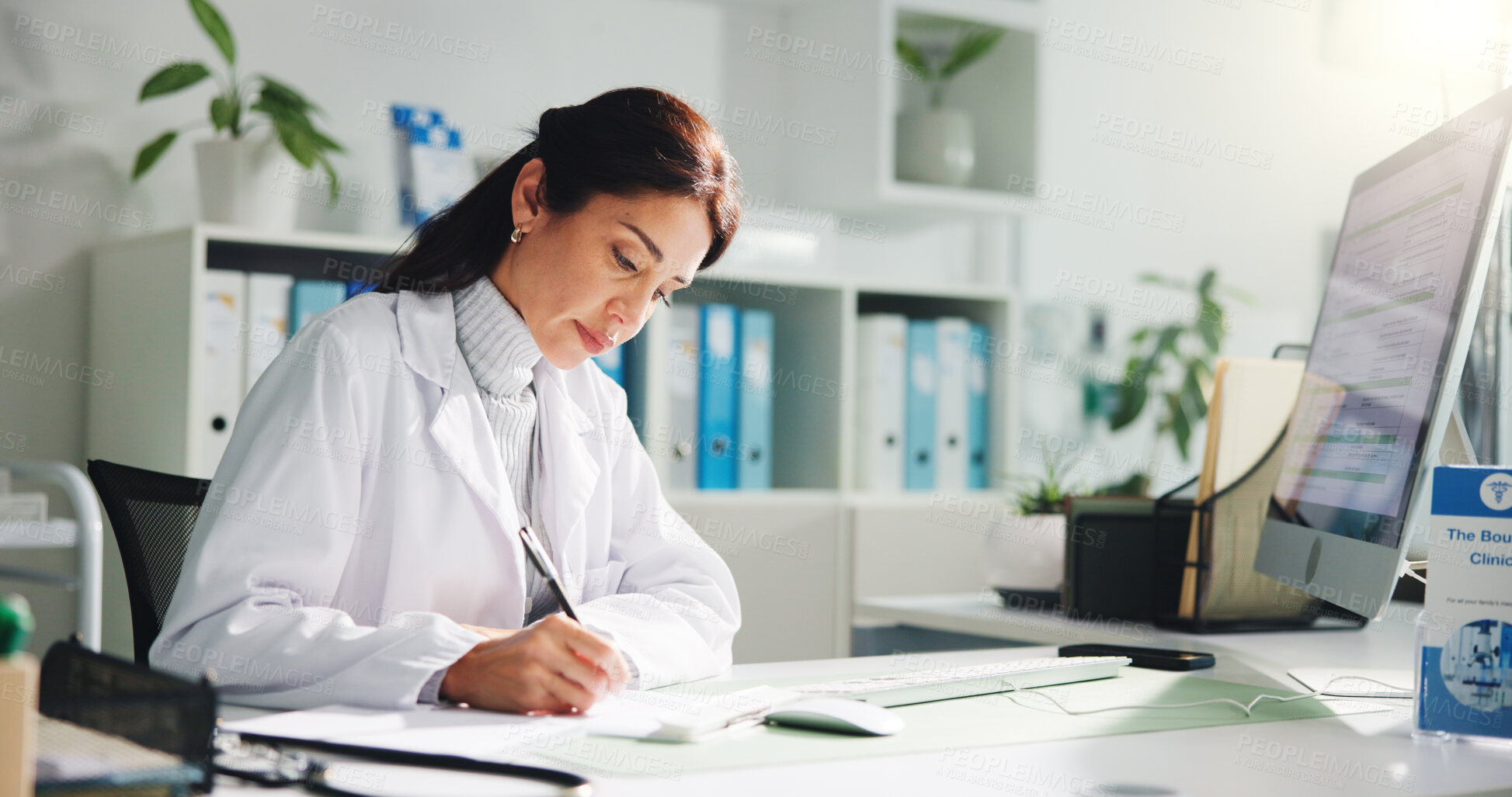 Buy stock photo Computer, woman and doctor writing report in clinic for research, diagnosis or treatment. Tech, medical service and female healthcare worker with referral document for paperwork in hospital office