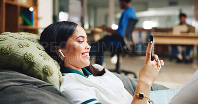Buy stock photo Phone, woman and student relaxing in library with networking, connectivity or contact on mobile app. Earphones, bean bag and person with cellphone for texting with communication online on campus.