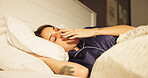 Comfortable, sleeping and yawn with woman in bed for morning or weekend break and wellness. Fatigue, rest and tired with person asleep in bedroom of apartment for dream, exhaustion or recovery
