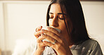 Woman, drinking and coffee in bedroom at house for morning start, enjoy espresso and smell aroma. Female person, thinking and beverage for peace, nostalgia memories and herbal tea of wellness in home