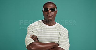 Buy stock photo Black man, fashion and sunglasses with arms crossed, style and confidence on green studio background. Portrait, male person or serious African model with accessory, shades or eyewear on mockup space