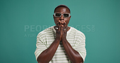 Buy stock photo Portrait, sunglasses and black man with surprise, shock or wtf emoji for fashion sale. Wow, rumour and person with omg reaction for secret, discount or gossip with space on green studio background