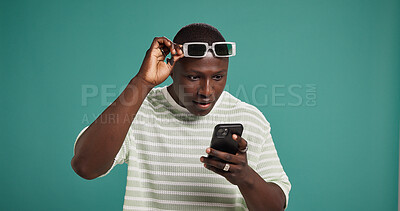 Buy stock photo Surprise, smartphone and black man in studio, wow or announcement on green background. African person, mobile user and cellphone with facial expression, space or shocked with reaction or notification