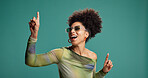 Pointing, dancing and african woman in studio with fashion, energy and moves for celebration. Happy person, excited and gesture for groove, sunglasses or good mood on green background with space