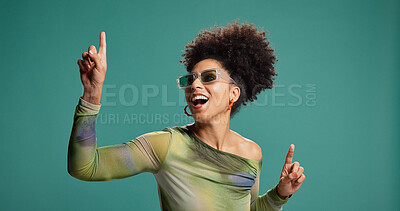 Buy stock photo Pointing, dancing and african woman in studio with fashion, energy and moves for celebration. Happy person, excited and gesture for groove, sunglasses or good mood on green background with space