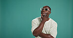 Black man, fashion and sunglasses with thinking, style and confidence on green studio background. Gen Z, male person or serious African model with accessory, shades or eyewear on mockup space