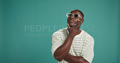 Buy stock photo Black man, fashion and sunglasses with thinking, style and confidence on green studio background. Gen Z, male person or serious African model with accessory, shades or eyewear on mockup space