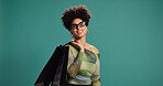 Portrait, discount and woman with shopping bag, studio or happy for fashion, pride and mockup space. Green background, shopper and African person with products on sale, smile and customer with gift