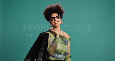 Buy stock photo Portrait, discount and woman with shopping bag, studio or happy for fashion, pride and mockup space. Green background, glasses and African person with products on sale, smile and customer with gift