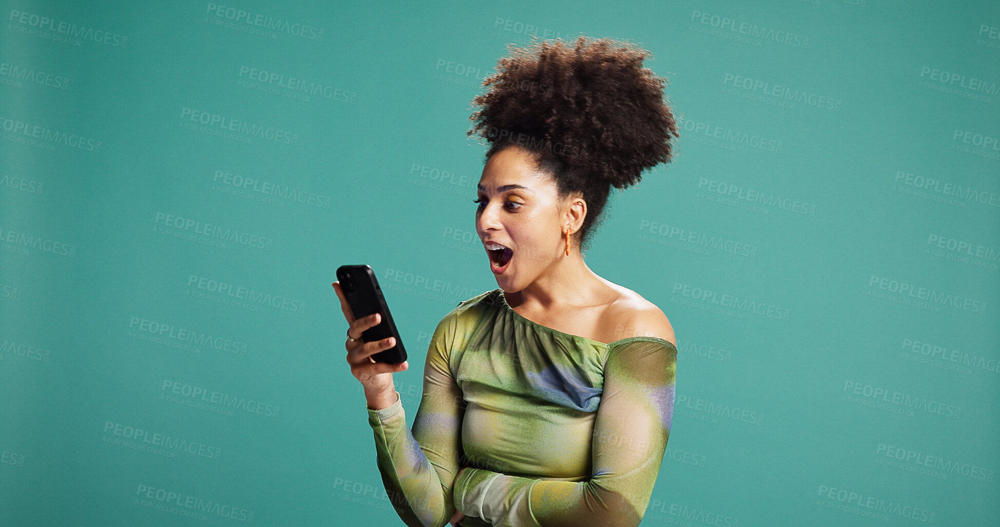 Buy stock photo Surprise, smartphone and woman in studio, wow and announcement on green background. Person, mobile user or cellphone with facial expression, space or shocked with emoji, discount deal or notification