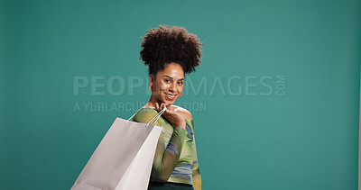 Buy stock photo Portrait, happy and woman with shopping bag, studio or discount for fashion, pride and mockup space. Green background, shopper and African person with products on sale, smile and customer with gift