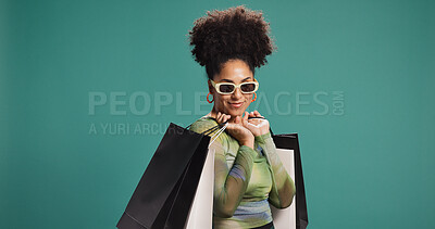 Buy stock photo Confident, happy and woman with shopping bag, studio or discount for fashion, mockup space and gift. Green background, shopper and African person with products on sale, smile and customer with shades