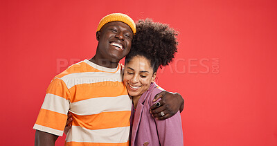 Buy stock photo Hug, smile and black couple in studio, love and bonding together on red background. Romance, embrace and man with woman, relationship and support with happiness, trust and commitment with marriage