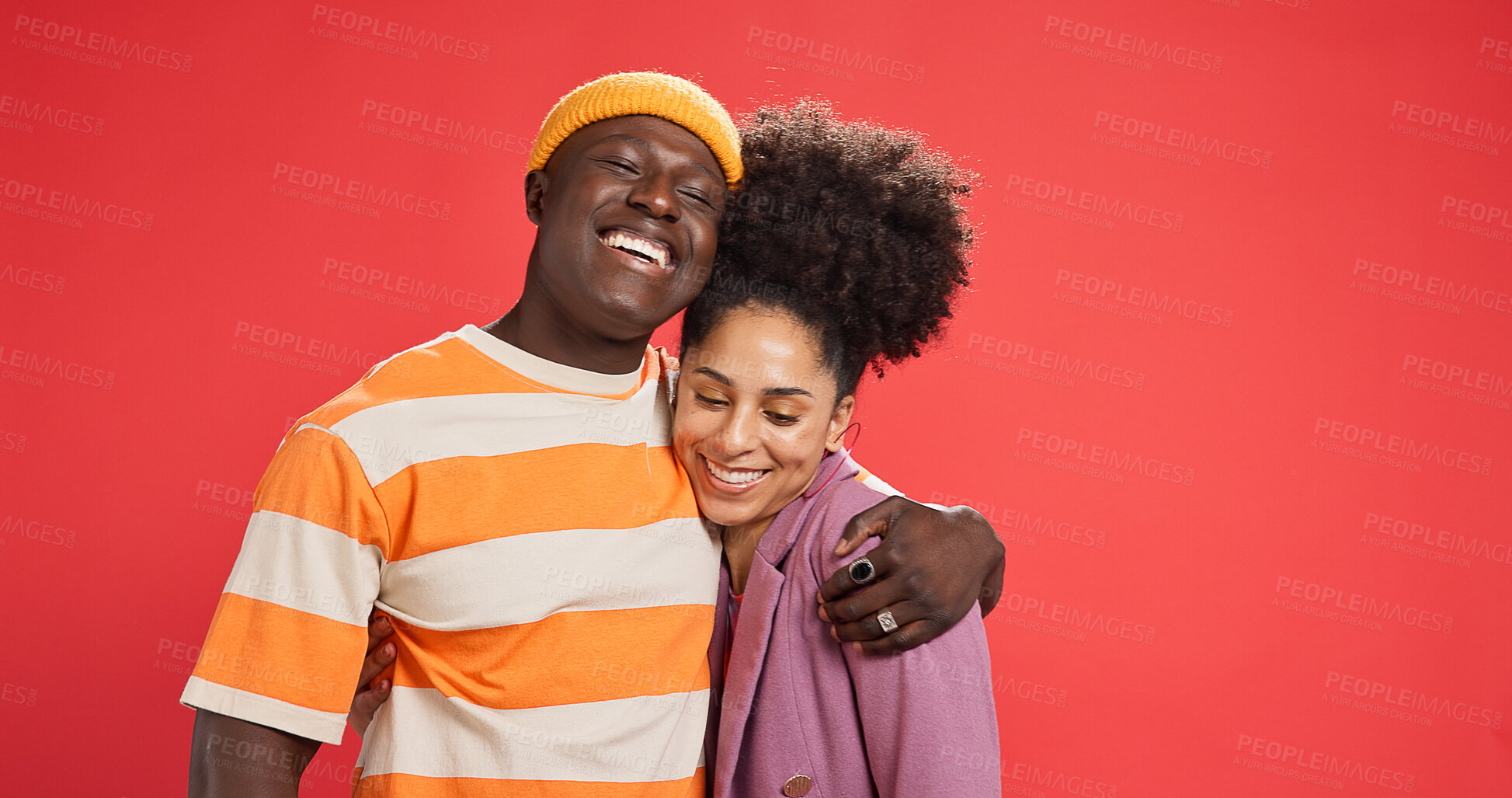 Buy stock photo Hug, smile and black couple in studio, love and bonding together on red background. Romance, embrace and man with woman, relationship and support with happiness, trust and commitment with marriage