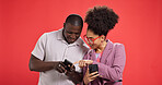 Happy couple, fashion or blog with phone in studio for social media or news on red background. Online post, notification or people with smile or mobile app for chat message, ideas or trendy clothes