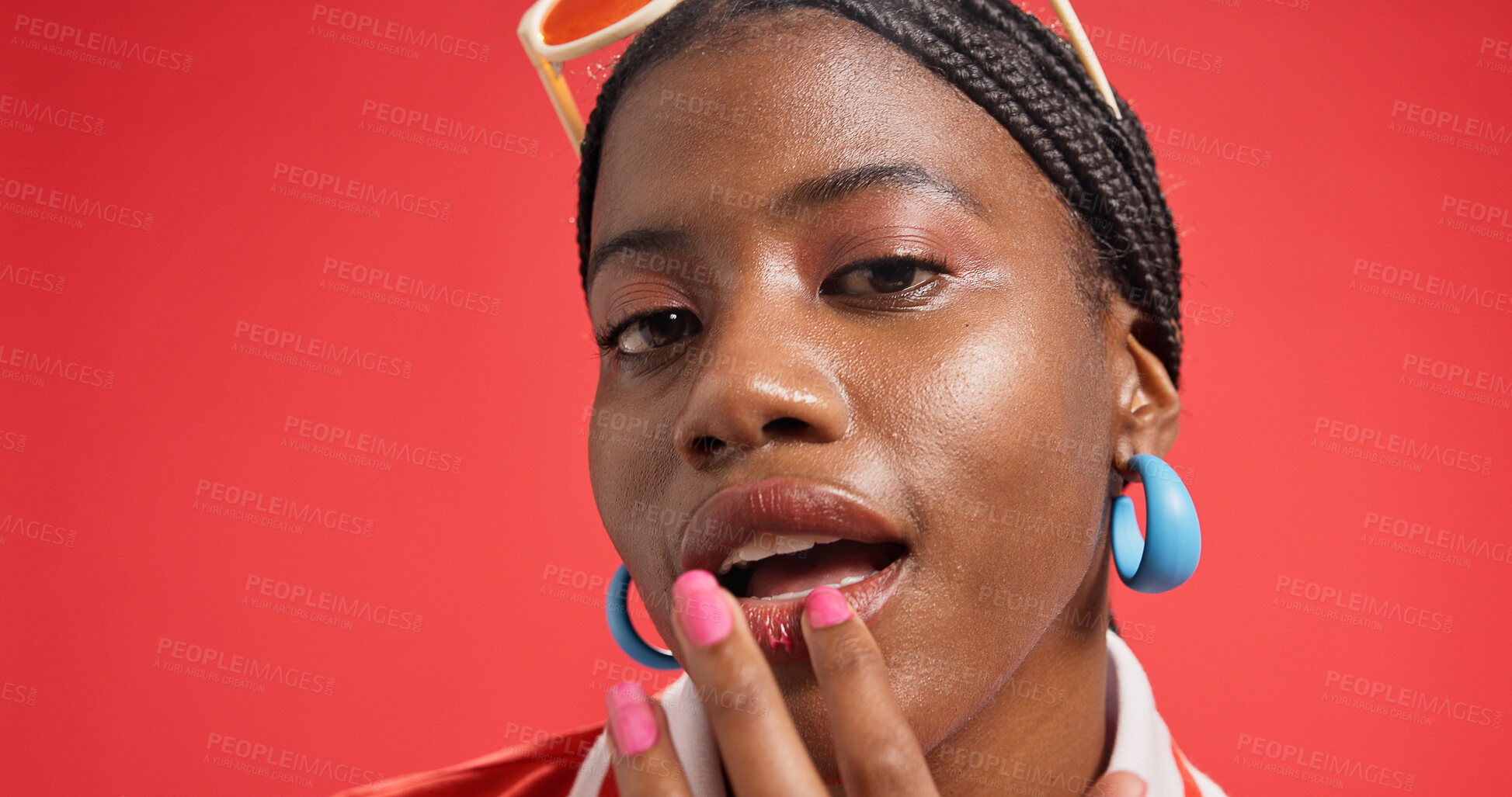 Buy stock photo Black woman, portrait and lips with makeup in studio for fashion on a red background. Face, female person or African model with beauty cosmetics, cool accessories or style for cosmetology on space