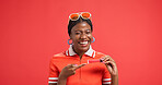 Portrait, lip gloss and black woman in studio, pointing and promotion on red background. African person, face and model with cosmetics, announcement and advertising space with beauty and smile