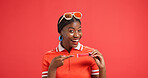 Portrait, lipstick and black woman in studio, pointing and announcement on red background. African person, face and model with cosmetics, promotion and advertising space with beauty and excited