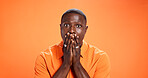 Man, reaction and surprised by news, portrait or expression for gossip, orange background or studio. Mockup space, black person and shocked by rumor, wow and listening to announcement in Kenya