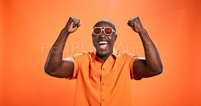 Buy stock photo Winner, black man and fist pump for celebration in studio with sunglasses for fashion prize. Yes, goal achievement and person cheering for success, cool giveaway or excited for victory on background
