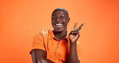 Buy stock photo Laugh, black man and peace sign in studio for fashion as social media influencer with trendy style. Smile, funny person and v hand gesture, portrait or content creator on orange background with space