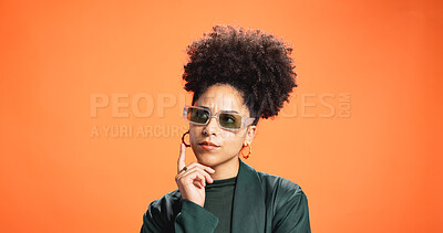 Buy stock photo Thinking, fashion and sunglasses with woman in studio for idea, style decision and reflection. Vision, wardrobe inspiration and brainstorming with person on orange background for solution and space