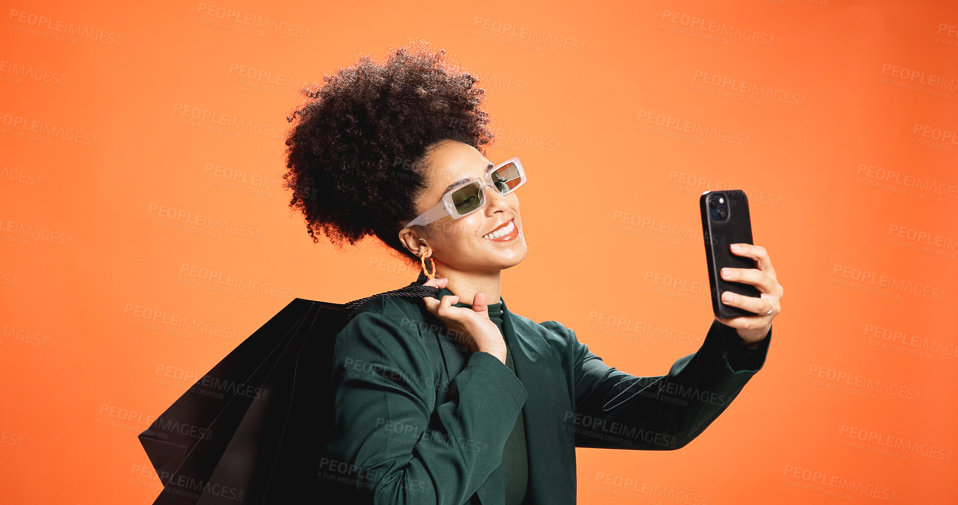 Buy stock photo Fashion, selfie and woman with shopping bag, studio and smile for discount, profile picture and web. Orange background, shopper and African person with giveaway, photography and post on social media