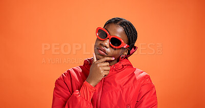 Buy stock photo Sunglasses, thinking and black woman with fashion, vision or gen z style in studio. African person, shades and idea with reflection, mindset or planning for cool outfit on orange background space