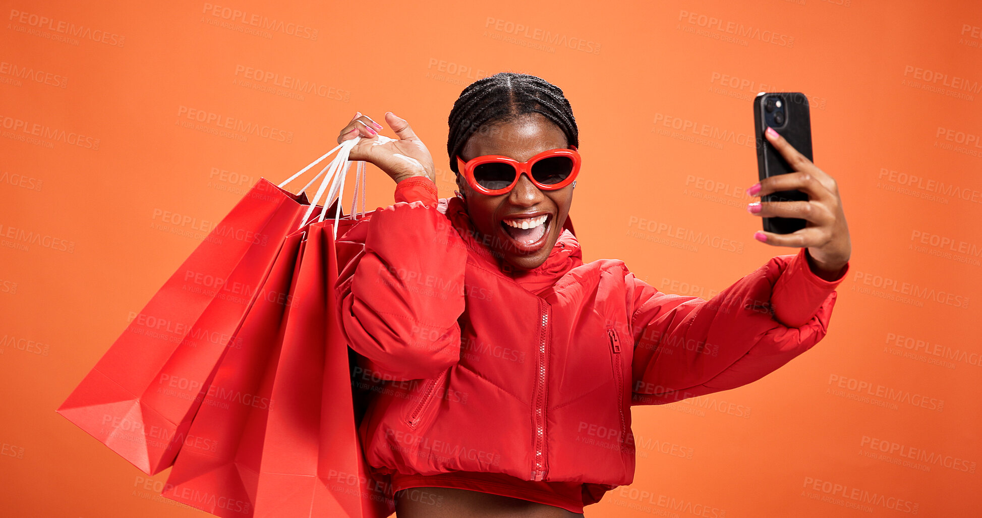 Buy stock photo Selfie, smile and woman with shopping bag, studio and discount for fashion, profile picture and web. Orange background, shopper and black person with giveaway, photography and post on social media