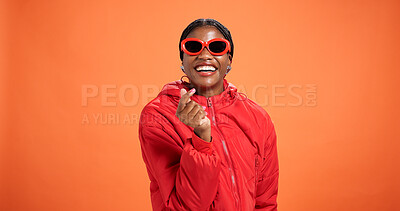 Buy stock photo Heart, fashion and portrait of woman in studio for love, support and trendy style on orange background. Happy, smile and person with emoji, gesture and fingers for gratitude, thank you and confidence