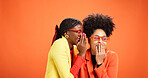 Gossip, secret and whisper with friends in studio for information, announcement and news. Wow, surprise and communication with African people on orange background for space, story and privacy