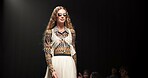 Woman, model and walking on catwalk with style, confidence or showcase with audience. Fashion, sunglasses and person at black background space with designer clothing, brand ambassador or runway event