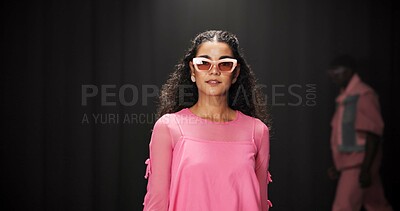 Buy stock photo Woman, model and portrait on catwalk with fashion, confidence or posing for showcase. Style, sunglasses and person at black background space with designer clothing, brand ambassador or runway event