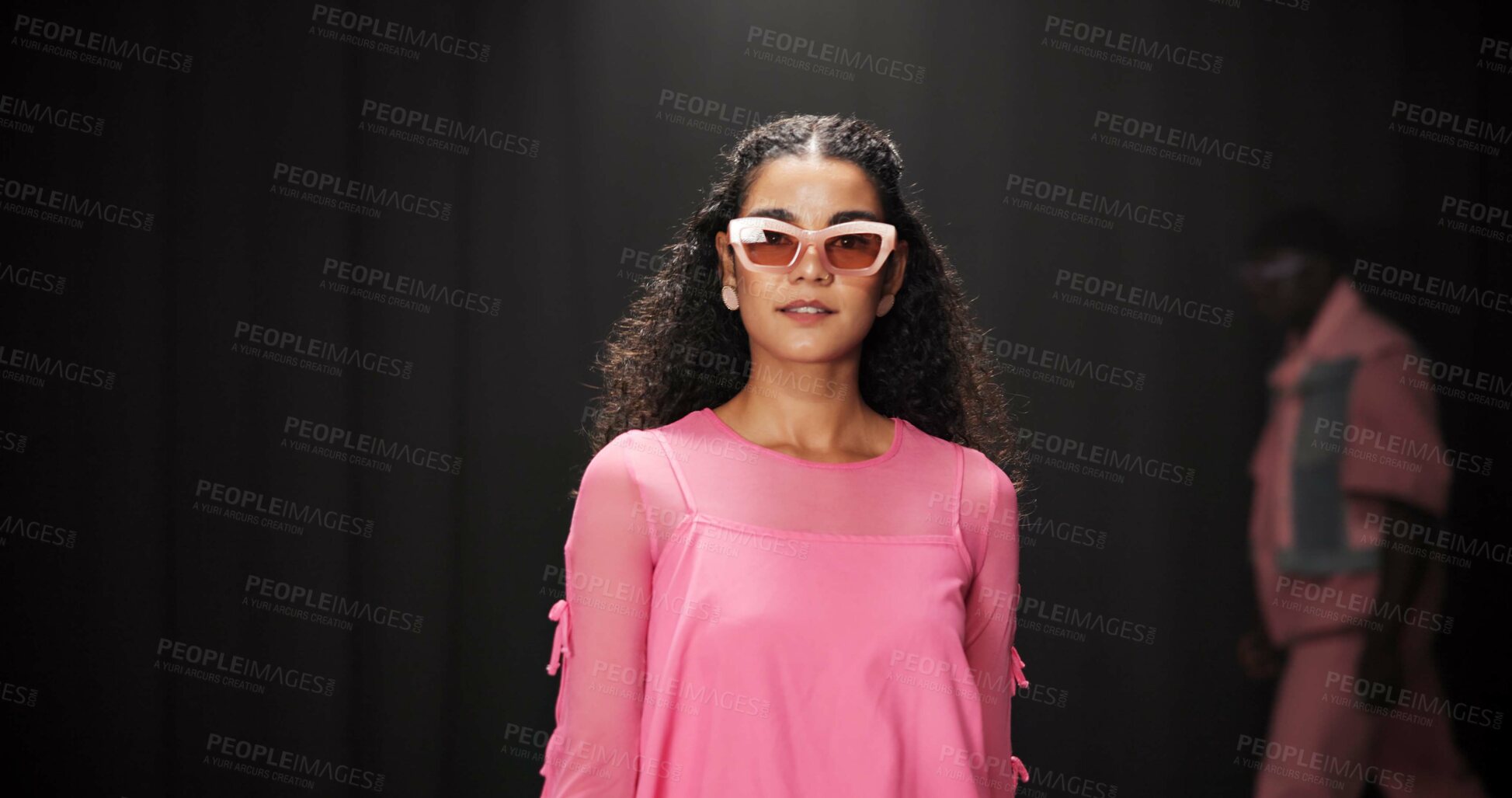 Buy stock photo Woman, model and portrait on catwalk with fashion, confidence or posing for showcase. Style, sunglasses and person at black background space with designer clothing, brand ambassador or runway event
