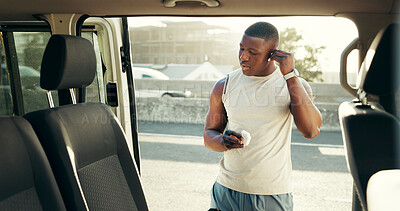 Buy stock photo Runner, earphones and car with black man in city for fitness playlist, health and audio. Marathon, workout podcast and streaming radio with person and vehicle for training songs, sports and sound