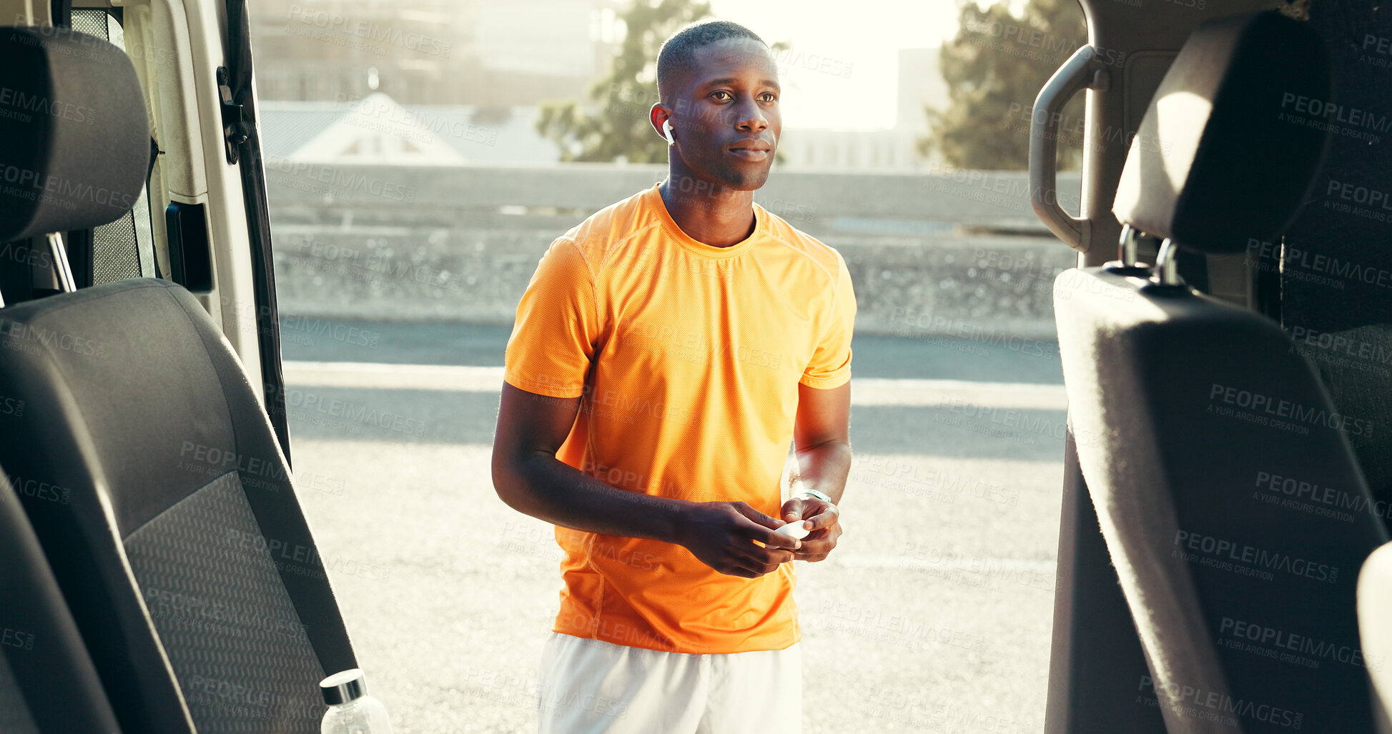 Buy stock photo Fitness, runner or earphones with music by car to start training, workout playlist or warm up song. Sports, black man and listen to audio on roadside for running break, cardio podcast or ready to jog