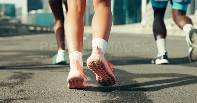 Buy stock photo Running, shoes and fitness with people in city for marathon, workout and training performance. Sports athlete, exercise and feet with group of friends in street for challenge, cardio and wellness