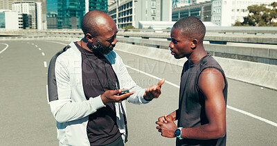 Buy stock photo Fitness, runner and coach with stopwatch in city for running time, progress and advice. Bridge, black people and personal trainer with stats for performance, workout pace and monitor marathon speed