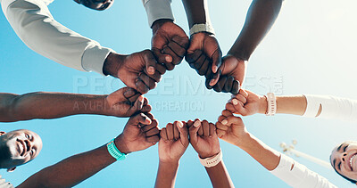 Buy stock photo Outdoor, group and fist bump for sports, celebration or collaboration for fitness, hands and circle. Blue sky, team and gesture for agreement, low angle and community with support, unity and success