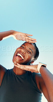 Buy stock photo Runner, hands frame and portrait with black woman in city for fitness, photography and wellness. Happiness, workout and marathon with low angle of person on blue sky for space, picture and smile