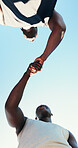 Fist bump, running and support with friends in city for team, fitness club and motivation. Sports challenge, exercise and connection with low angle of people for wellness, training and marathon