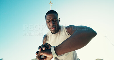 Buy stock photo Black man, runner and smart watch in city for fitness, stats and break with low angle for training. Person, athlete and heart rate with timer, stopwatch and app with sweat, workout and space in Kenya