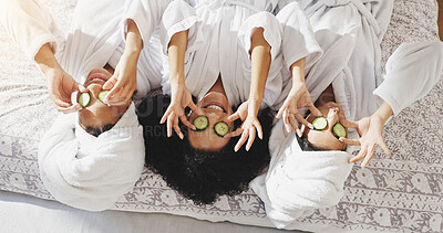 Buy stock photo Spa, cucumber and smile with friends in hotel for beauty treatment, bonding and hospitality. Skincare, facial and upside down with women in bedroom of resort for self care, pamper and travel