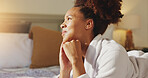 Woman, robe and thinking on bed in hotel room for luxury vacation, spa day promo and gratitude. Hospitality, african person and peaceful at accommodation for self care retreat, daydreaming or holiday