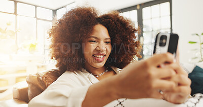 Buy stock photo African woman, phone and happy with texting on couch, relax and laugh at meme on web at house. Person, smartphone and smile in home, mobile app and chat notification on social media in living room