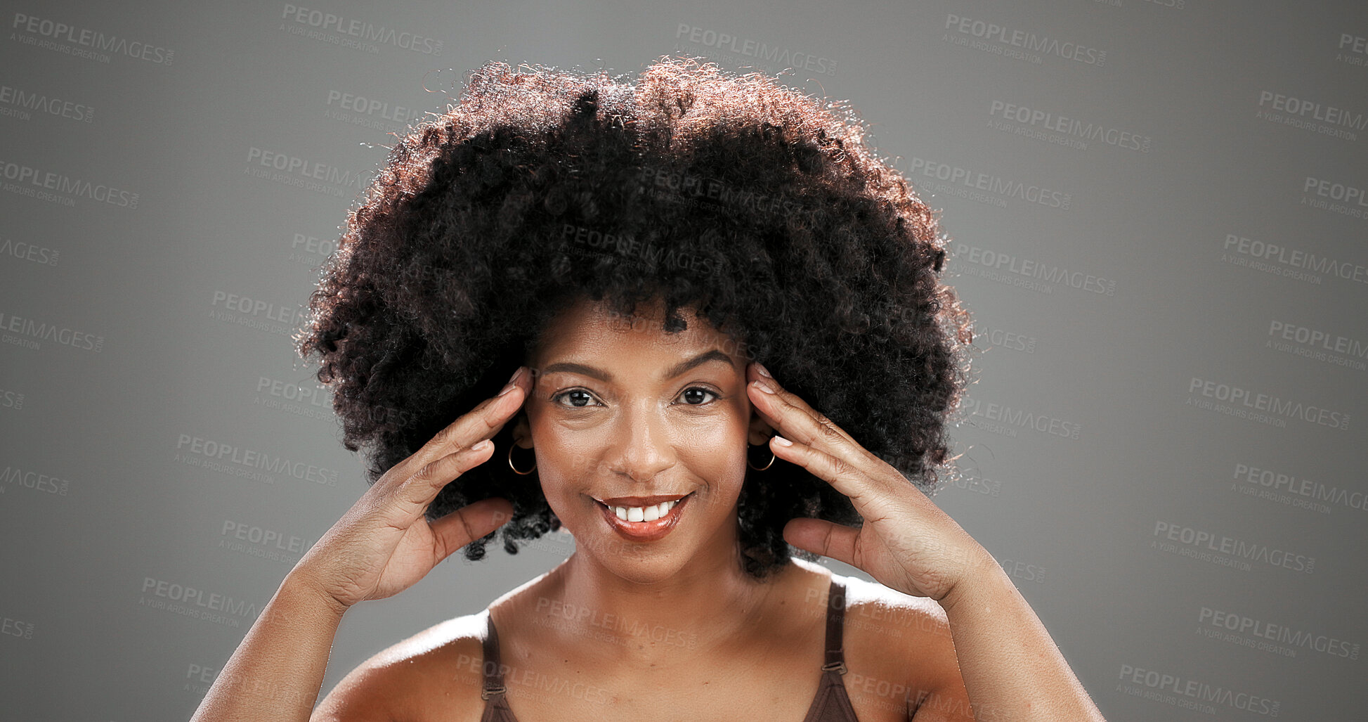 Buy stock photo Natural, beauty and portrait of black woman in studio for hair care, healthy texture or growth. Smile, mockup space and person with afro hairstyle for wellness, grooming or glow on gray background