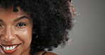Beauty, space and portrait of black woman in studio with natural hair, wellness and cosmetics. Happy, salon and face of person with afro hairstyle for texture, growth and shine on gray background