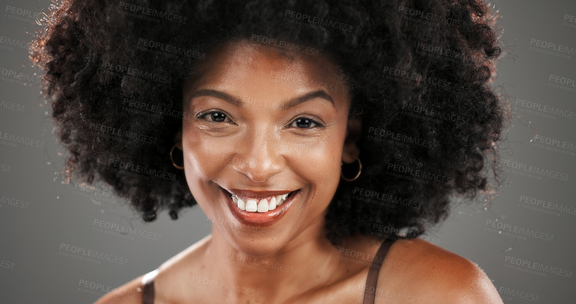 Buy stock photo Happy, beauty and portrait of black woman in studio with natural hair, wellness and cosmetics. Smile, salon and face of person with afro hairstyle for texture, growth and shine on gray background