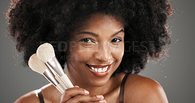 Buy stock photo Makeup, brushes and portrait of black woman in studio for foundation, cosmetics and beauty products. Cosmetology, happy and person with tools for skincare, makeover and aesthetic on gray background